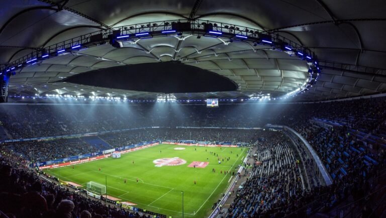 A high-angle view of a lit football (soccer) stadium
